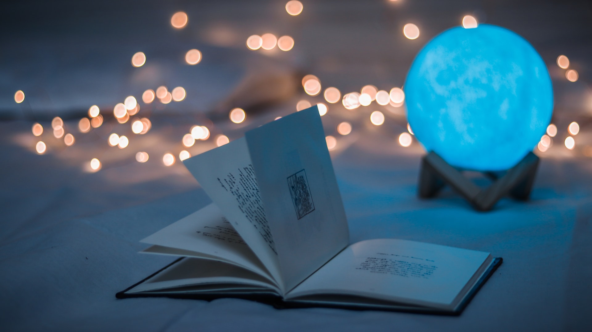 A mysterious book on a table with a glowing globe