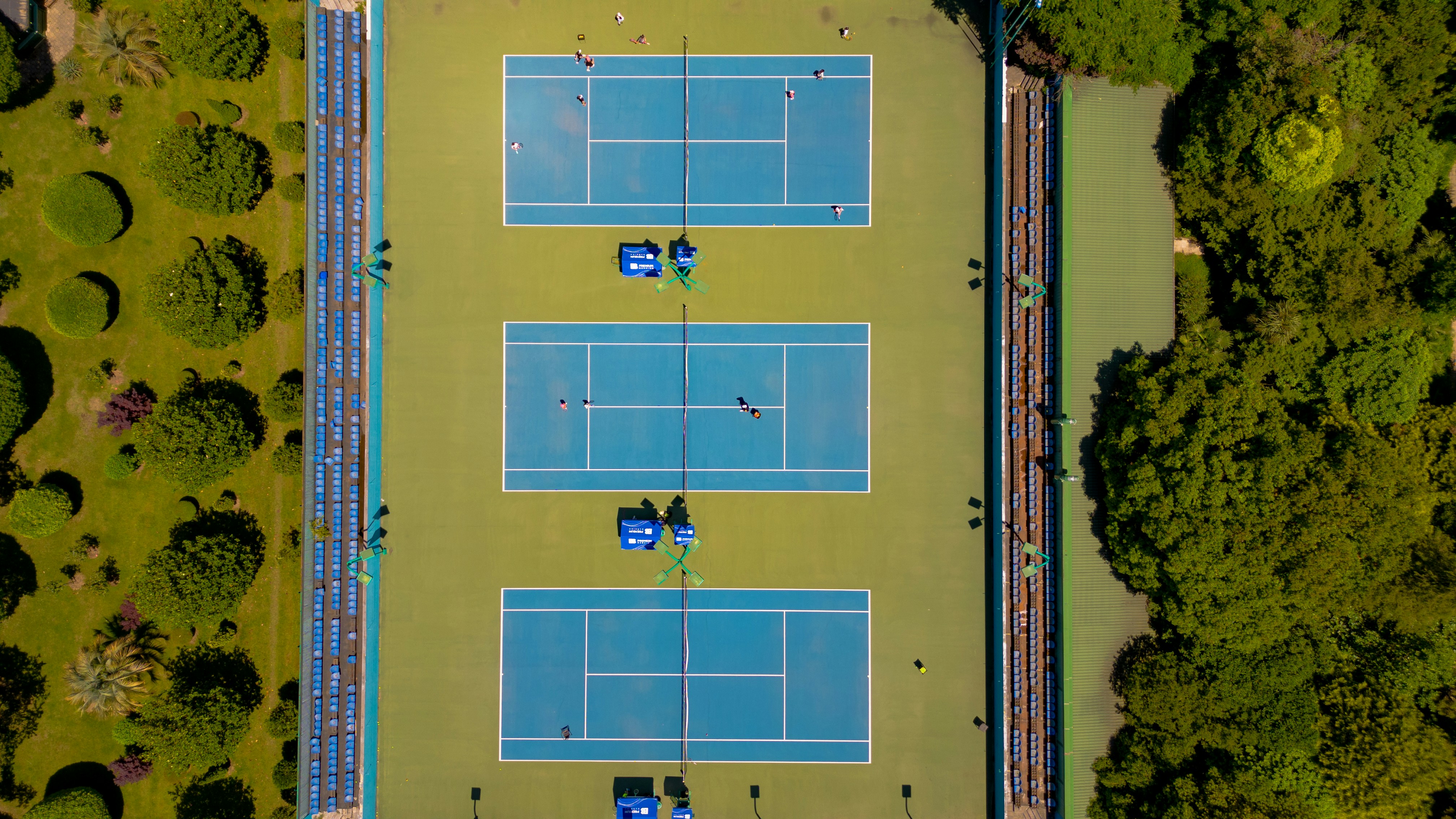 aerial view of three empty tennis courts